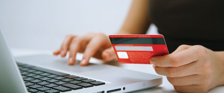woman using a computer with a credit card