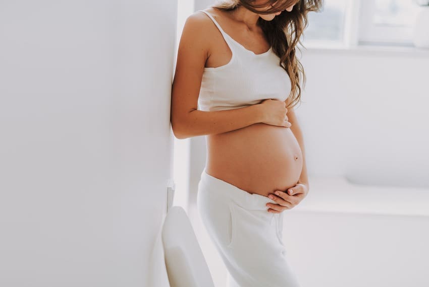 Pregnant Woman holding stomach