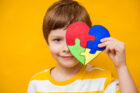 Boy with autism puzzle heart