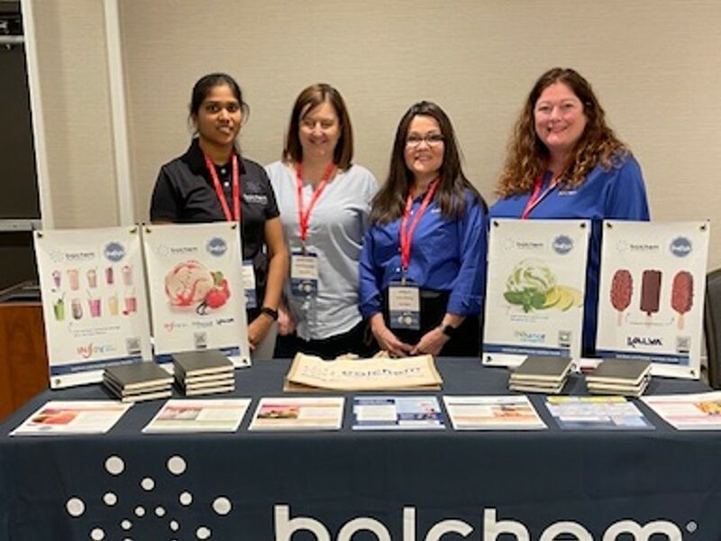 Image of four women at a Balchem booth