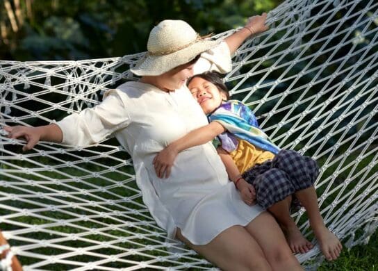 Woman and child sitting on a hammock