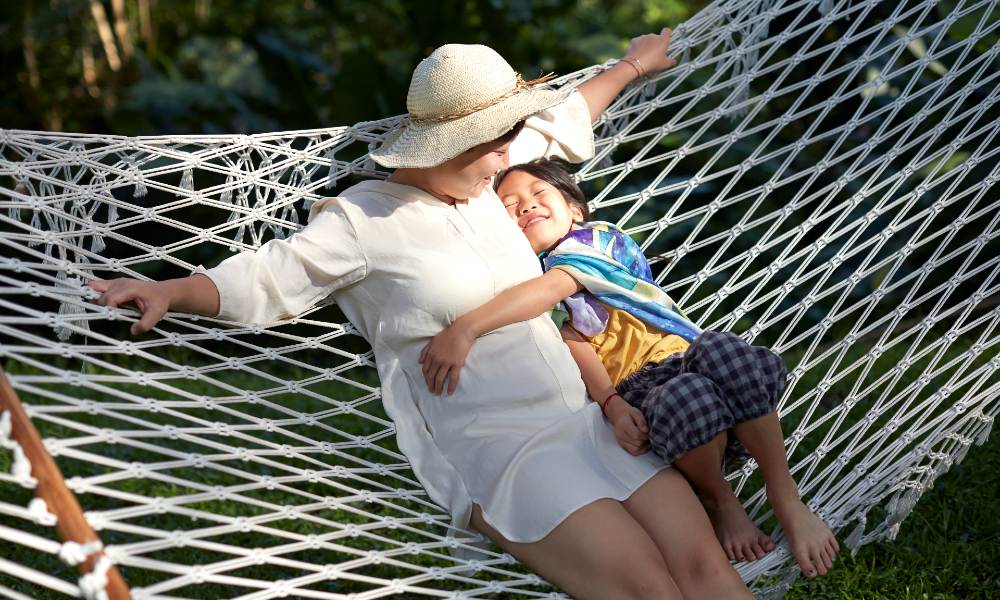 Woman and child sitting on a hammock