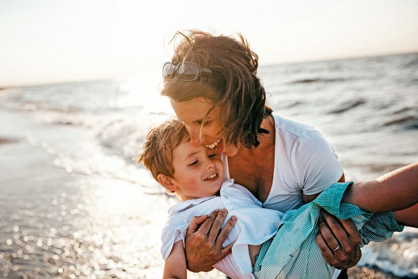 Happy woman and boy on a beach