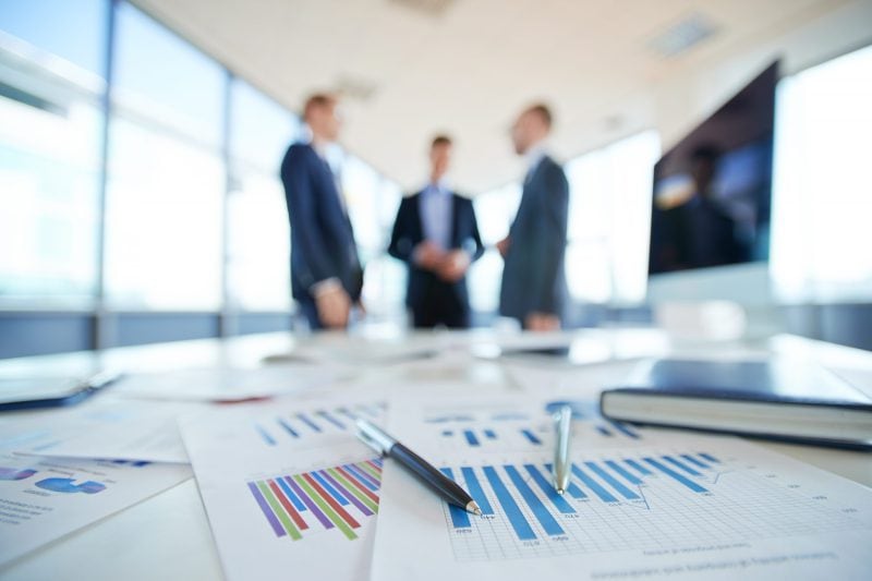 Financial documents and charts on a table.
