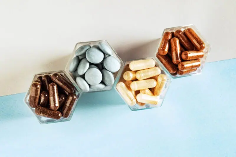 Various capsules with dietary supplements representing Zinc Bisglycinate Chelate