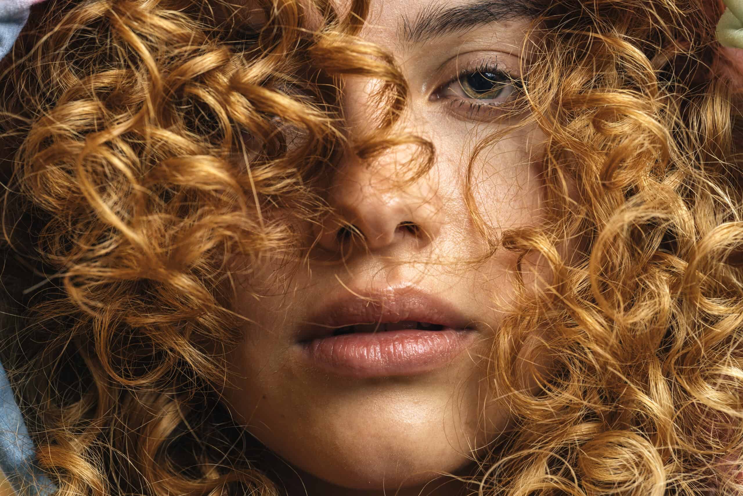Close Up Of Studio Portrait Of Young Woman Looking At Camera Beauty Within - msm and collagen curly red hair