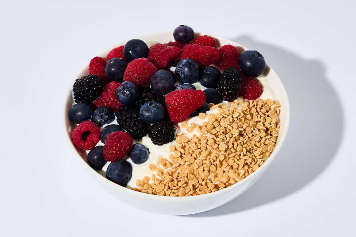 Image of a bowl of yogurt with balchem protein crisps and fruit.