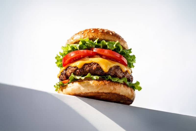 image of a hamburger on a ledge with balchem meatshure salts