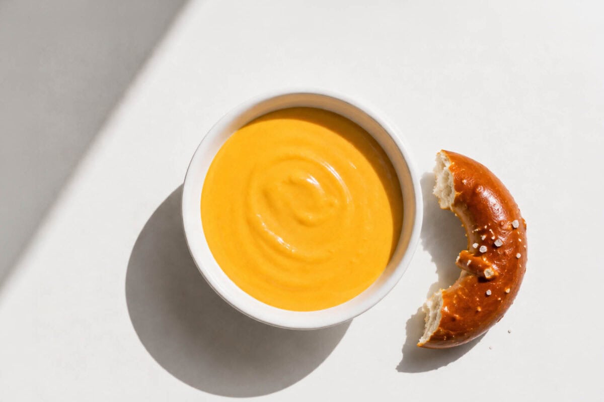 image of a cheese sauce with a pretzel