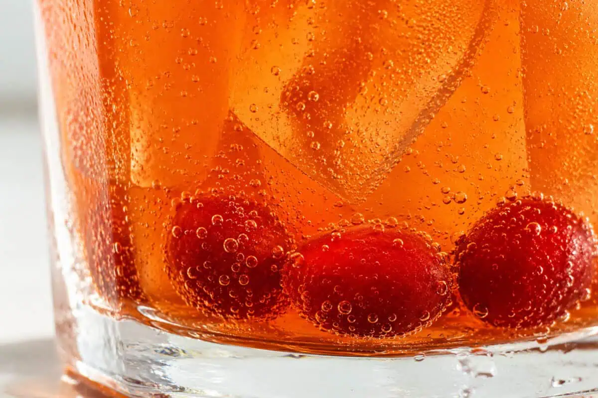 image of a drink with cranberries on the bottom