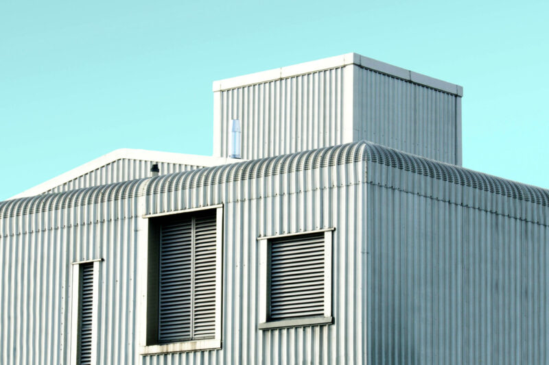 Modern building with corrugated metal and window slats.