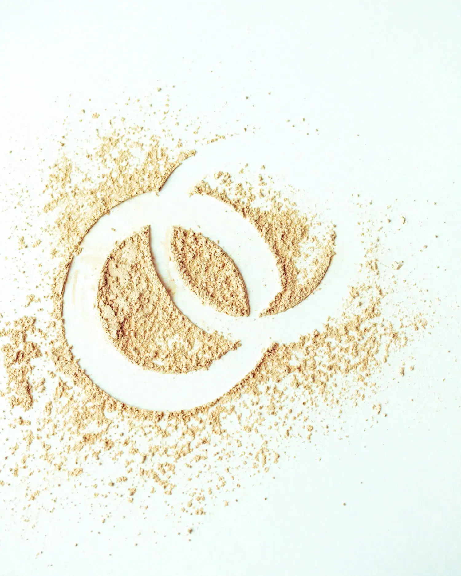 Powder on white surface forms interlocking circles.