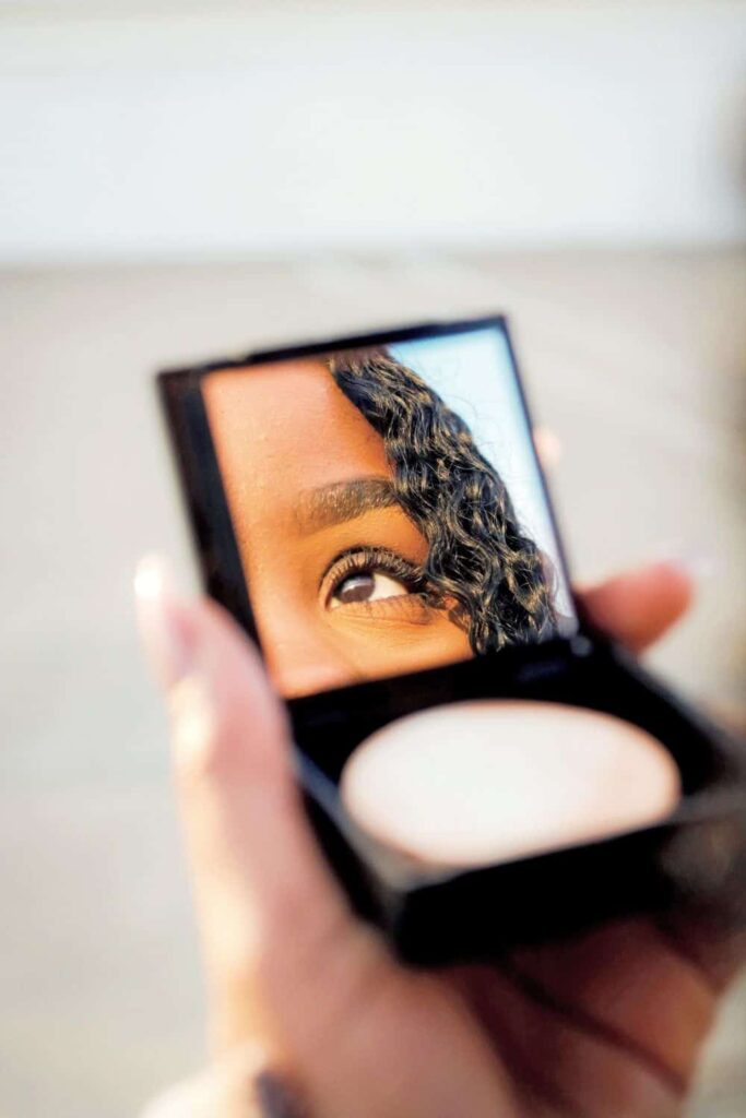 woman in mirror beauty care product