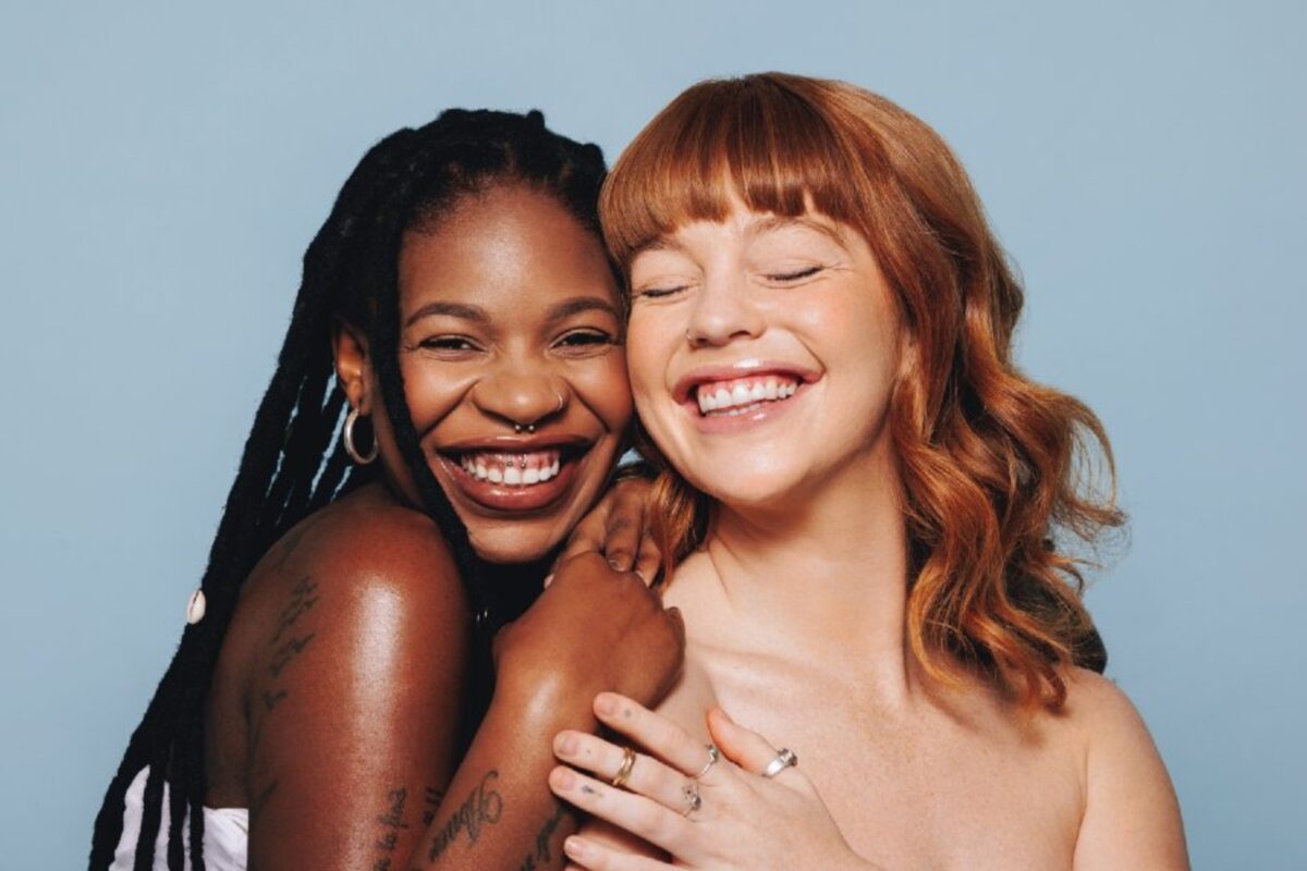 OptiMSM Longevity Young Woman Smiling 1000×600 (1) Two women with clear skin smiling.