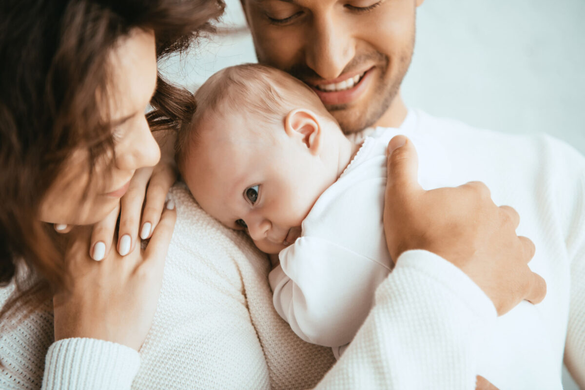 Family holding a baby