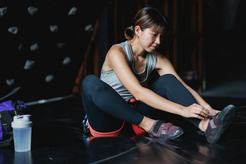 climber woman drinking creatine for sports