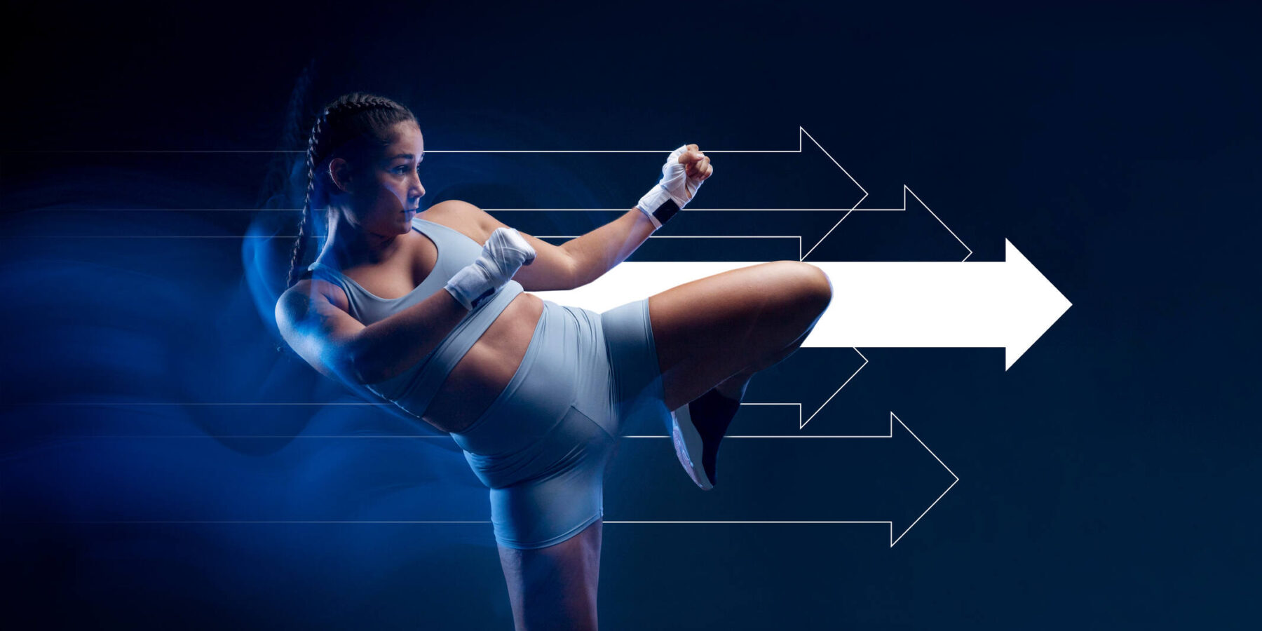 Image of a woman kicking with a white arrow behind