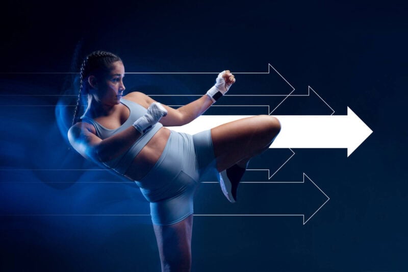 Image of a woman kicking with a white arrow behind