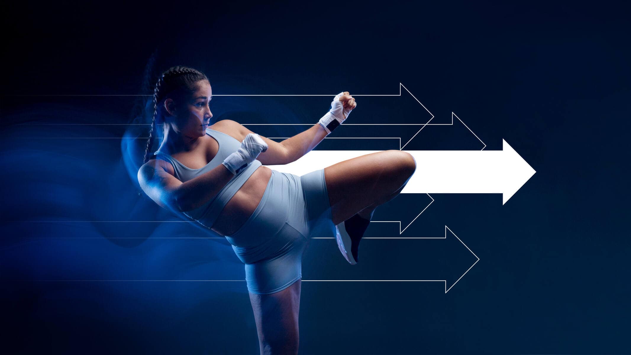 HNH_Woman-kickboxing_2133x1200 Image of a woman kicking with a white arrow behind