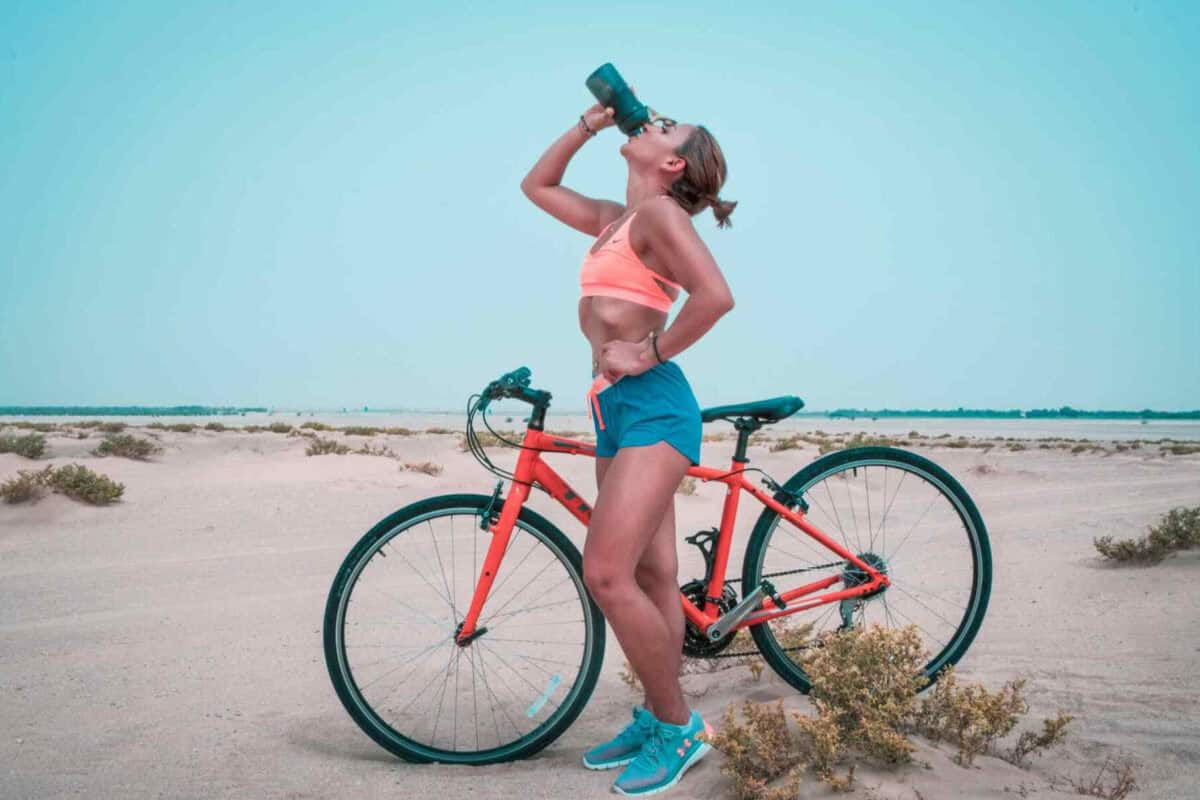 Pexels Thelazyartist 1302928 (2) (1) (1) Woman Drinking on a bike Creatine for Sports