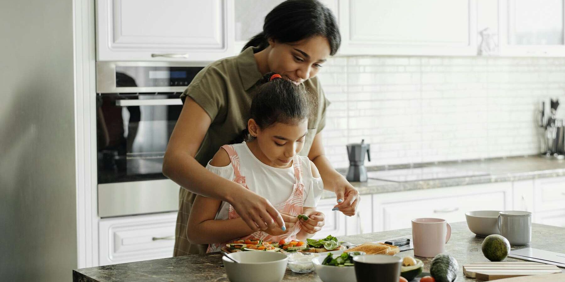 image of a mother and daughter cooking