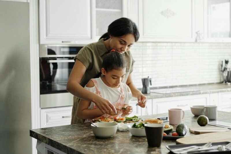 image of a mother and daughter cooking