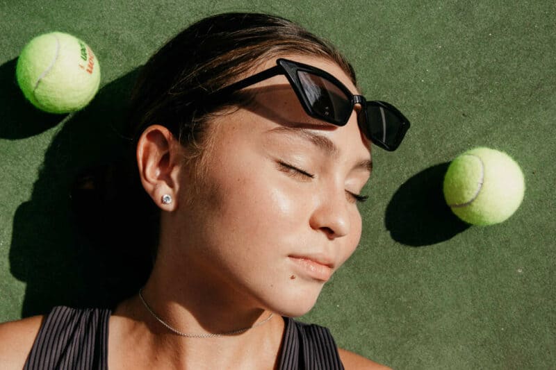 Woman by tennis balls
