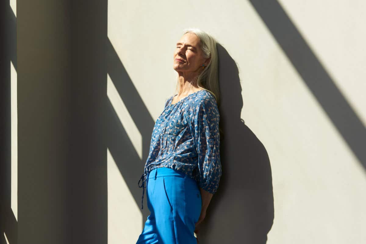 image of a woman leaning on a wall