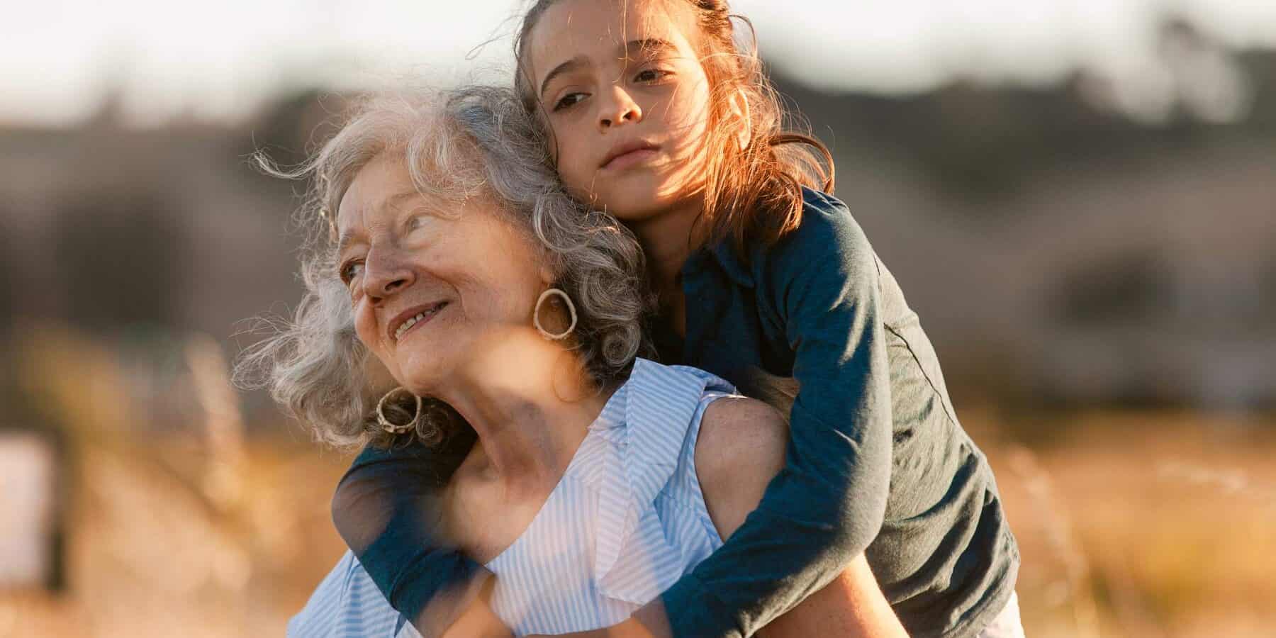 Older woman with a little girl on her back