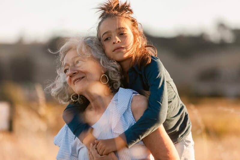 Older woman with a little girl on her back