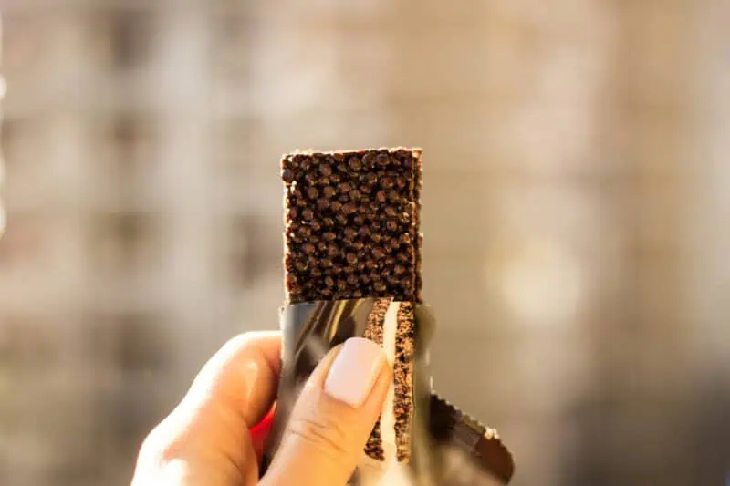 Image of a person holding a protein bar