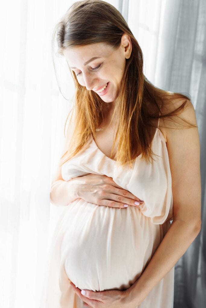 pregnant-woman-white dress_1200x1800 Image of a pregnant woman wearing a white dress