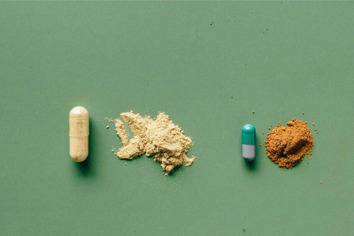 Excipients-pill-powder_1800x1201 Image of two pills with excipients powder on a green background