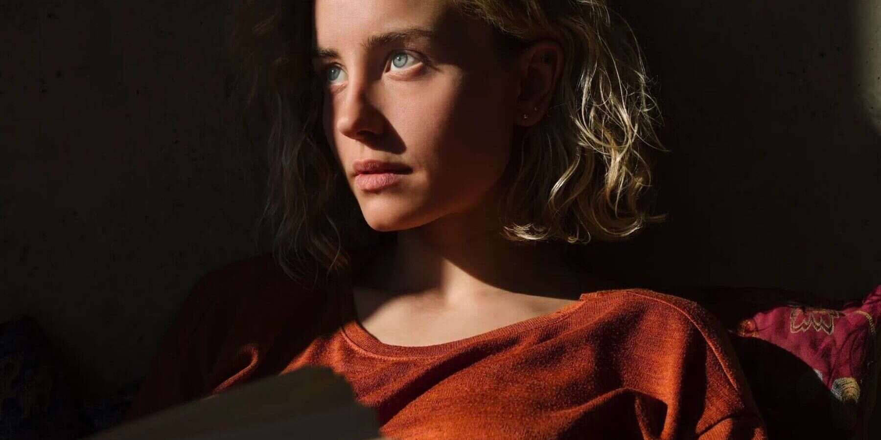 woman sitting with light on her face