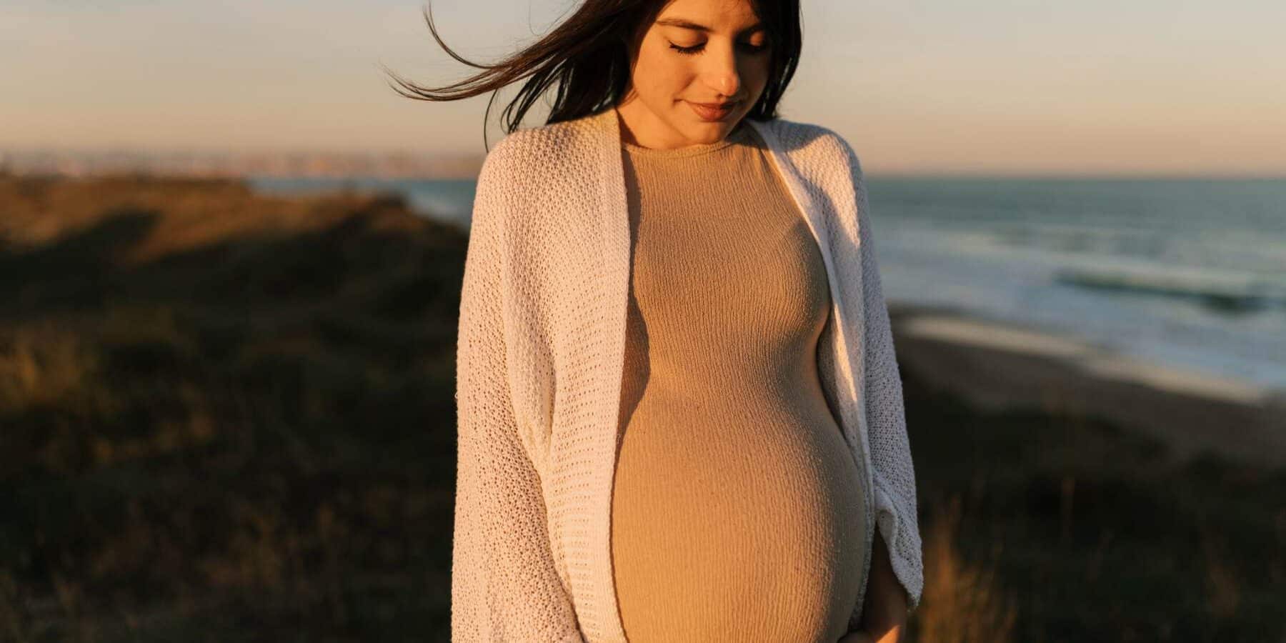 Image of a woman holding her pregnant belly