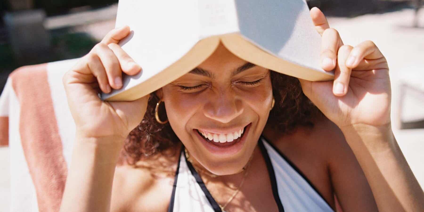 Image of a woman holding a book over her head