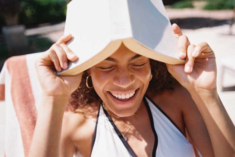 Image of a woman holding a book over her head