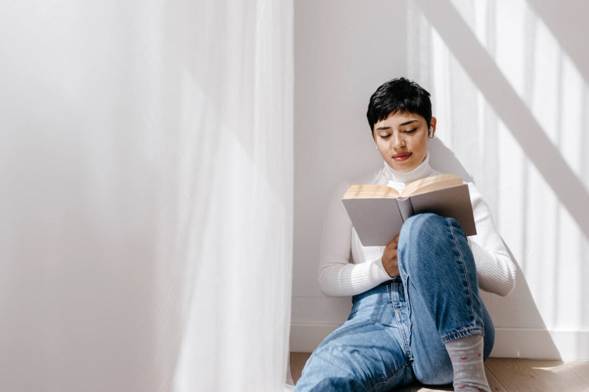 Image of a woman sitting reading a book