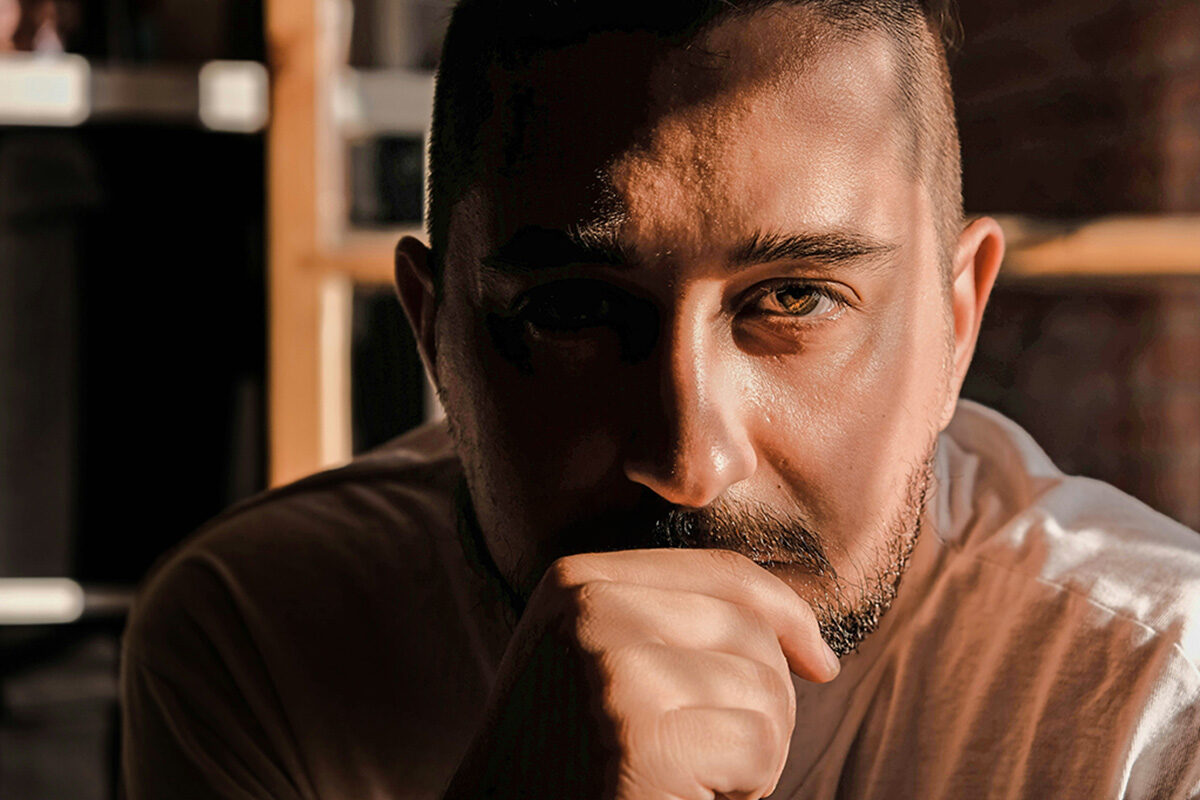 Man looking into camera thinking intently