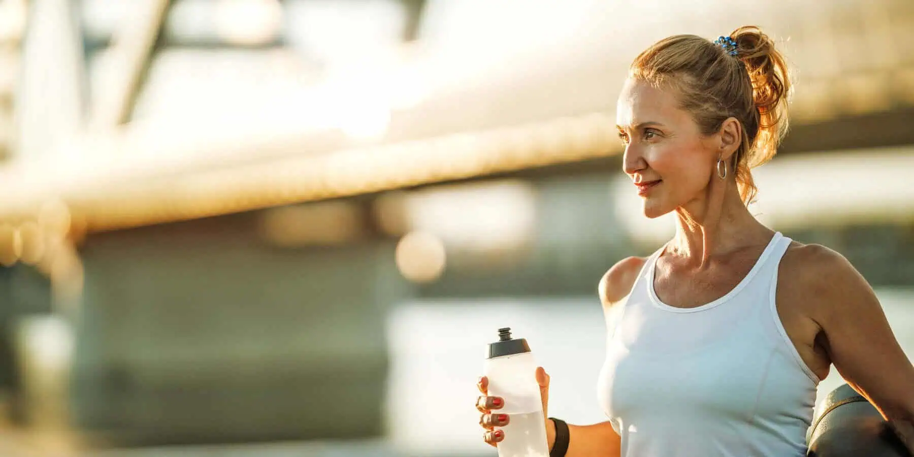 Image of a fit woman drinking water