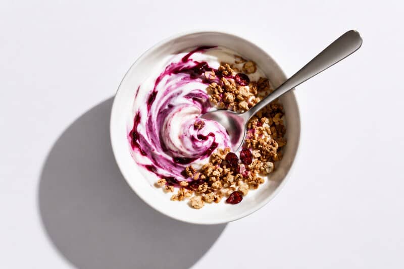Yogurt bowl topped with granola and berry mixture