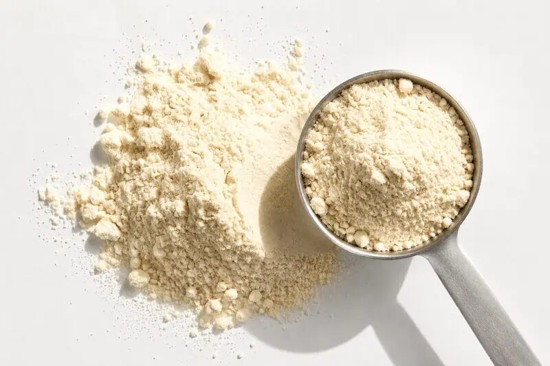 Scoop of fine powder beside a loose powder pile