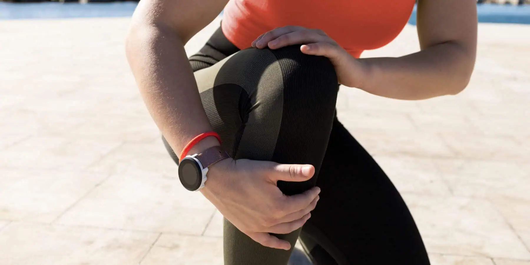 image of a woman bending over for her knee
